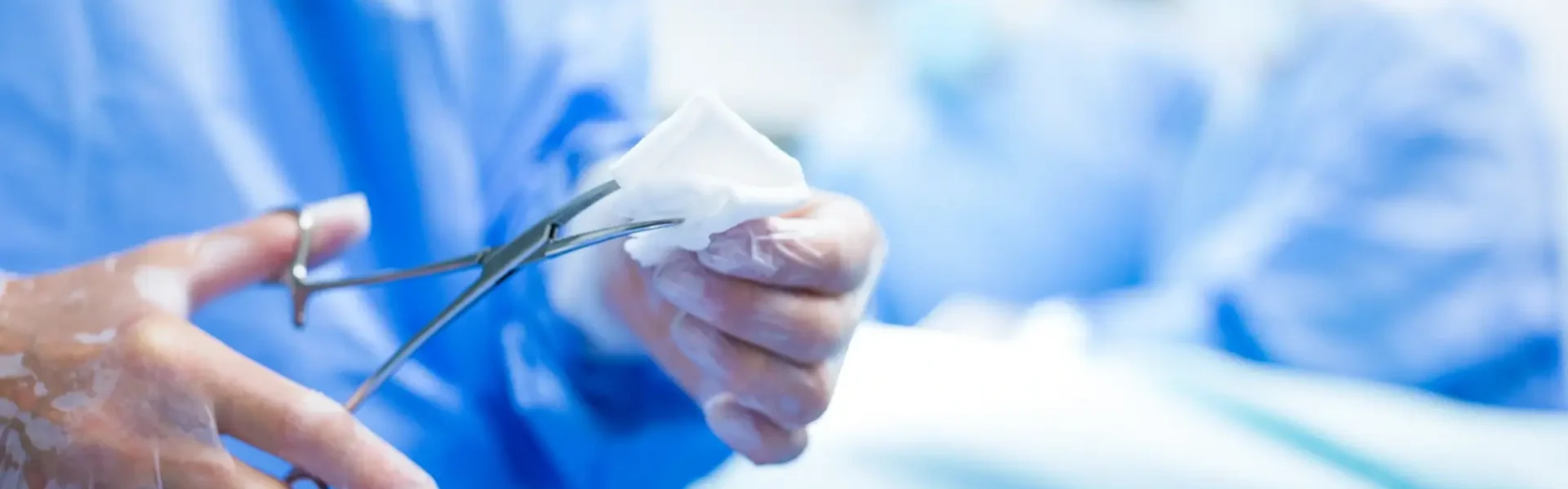 surgeon-cutting-cotton-from-scissor-operation-room 1